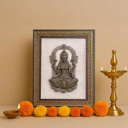 Decorative frame with a seated figure, surrounded by colorful pom-poms and a candlestick on a beige background