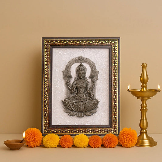 Decorative frame with a seated figure, surrounded by colorful pom-poms and a candlestick on a beige background